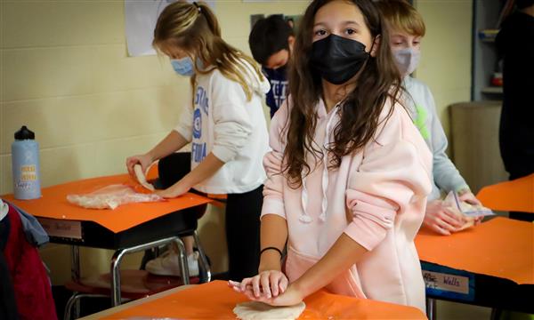 Girl flattens salt dough